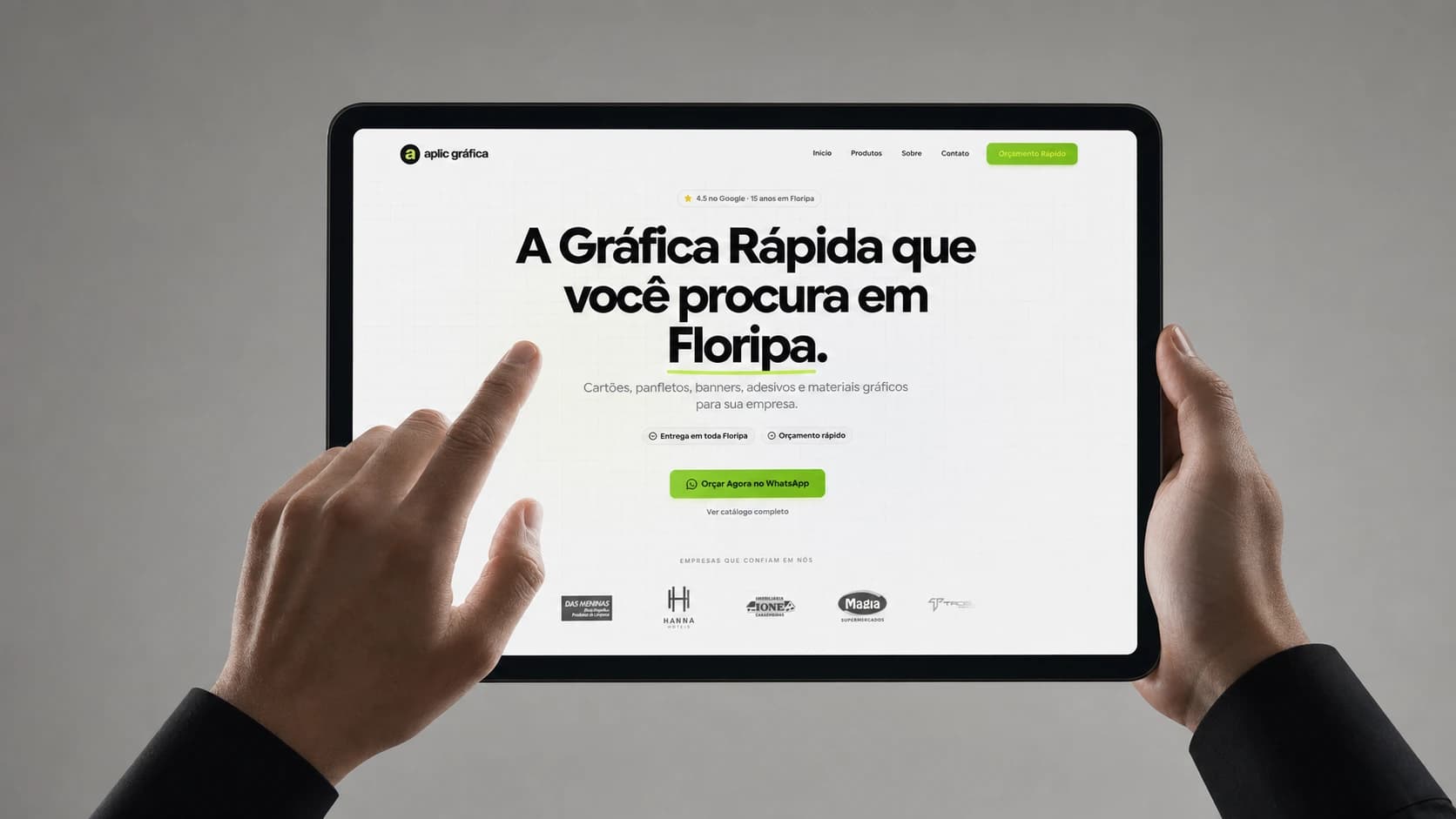 Site da Aplic Gráfica em um tablet sobre uma mesa de trabalho
